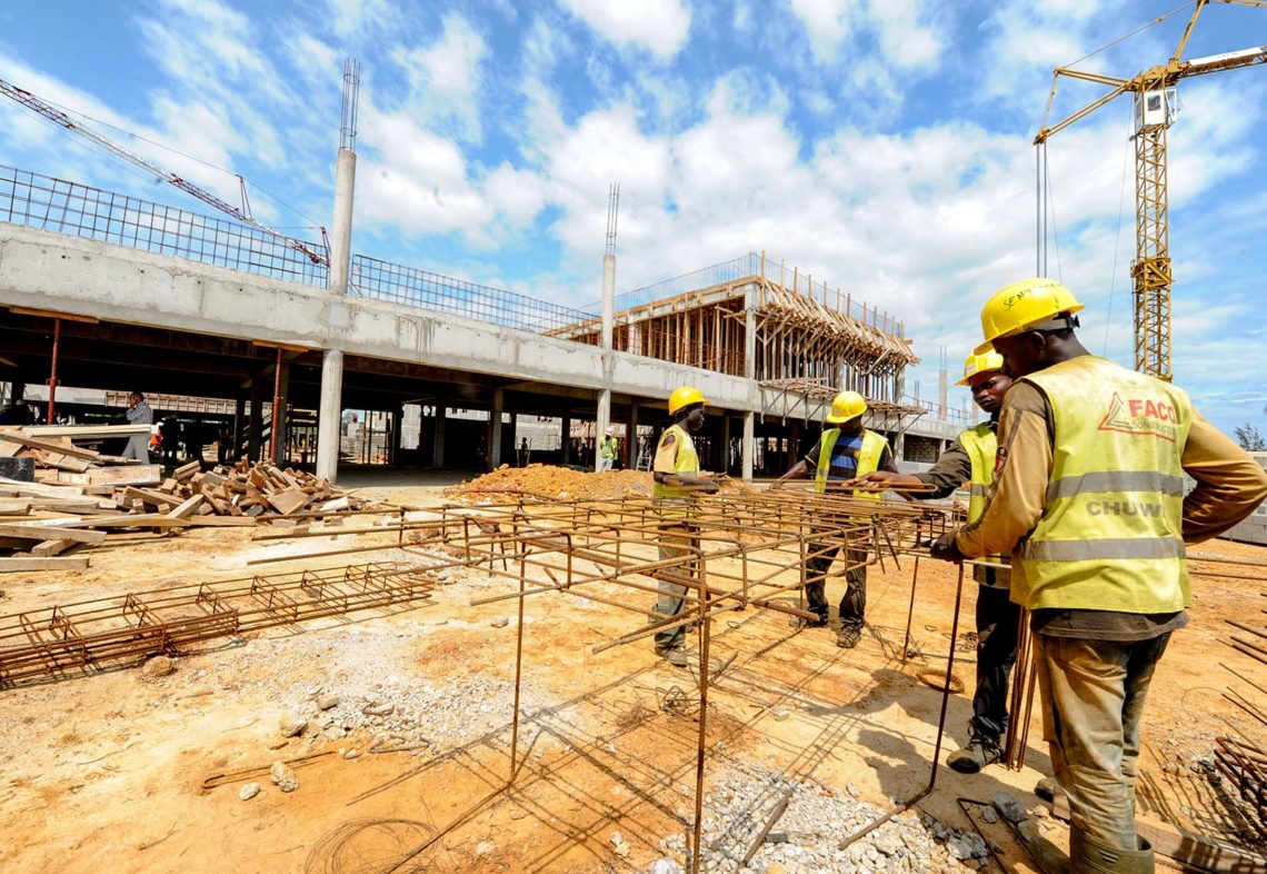 Workers work on the construction of a university hospital in Owendo, port of Libreville on October 11, 2012. Gabon has launched a 20 billion USD infrastructure investment plan, which aims to make the country an emerging country by 2025. AFP PHOTO / STEVE JORDAN        (Photo credit should read Steve Jordan/AFP/GettyImages)