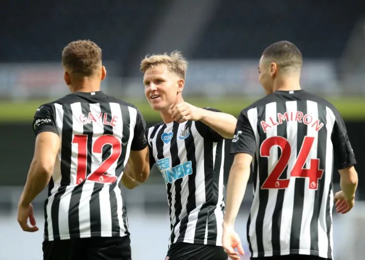 Newcastle United's English striker Dwight Gayle (L) celebrates with Newcastle United's Scottish midfielder Matt Ritchie (C) and Newcastle United's Paraguayan midfielder Miguel Almiron (R) after scoring a goal during the English Premier League football match between Newcastle United and Liverpool at St James' Park in Newcastle-upon-Tyne, north east England on July 26, 2020. (Photo by OWEN HUMPHREYS / POOL / AFP) / RESTRICTED TO EDITORIAL USE. No use with unauthorized audio, video, data, fixture lists, club/league logos or 'live' services. Online in-match use limited to 120 images. An additional 40 images may be used in extra time. No video emulation. Social media in-match use limited to 120 images. An additional 40 images may be used in extra time. No use in betting publications, games or single club/league/player publications. /